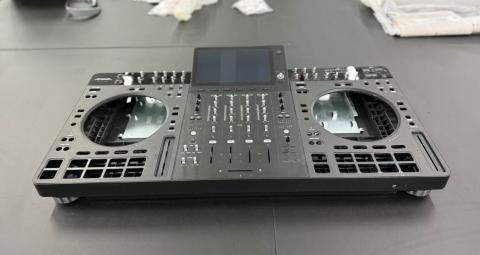 Behringer ANIMA prototype with central screen, four-channel mixer and empty jog-wheel and pad openings